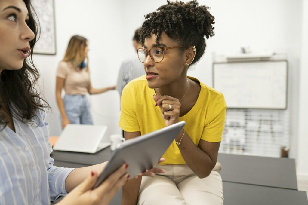 afro woman at work talking with colleagues